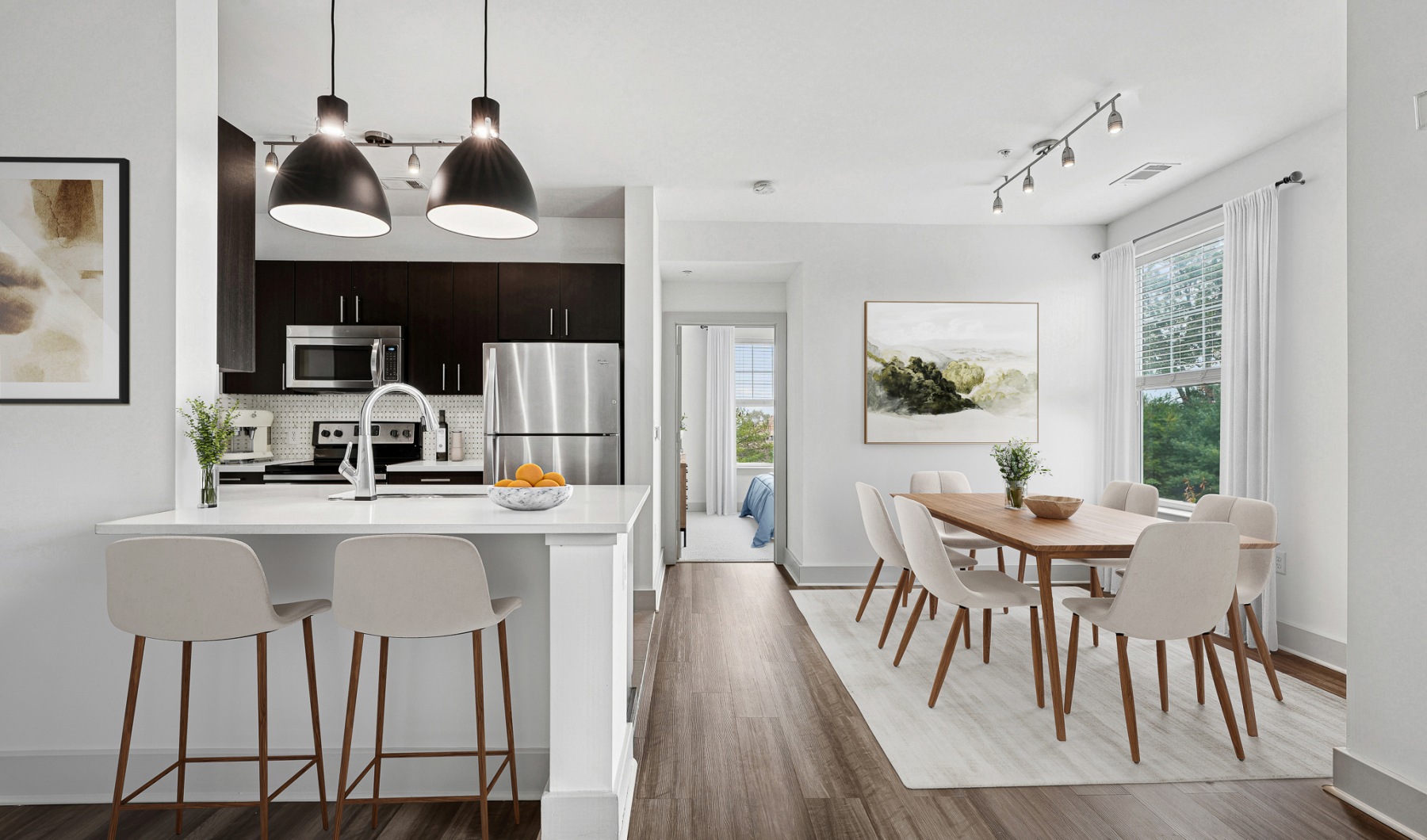 Renovated kitchen with new backsplash, stainless steel appliances and breakfast bar