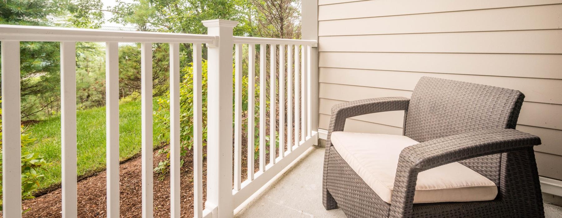 a white porch with a white railing