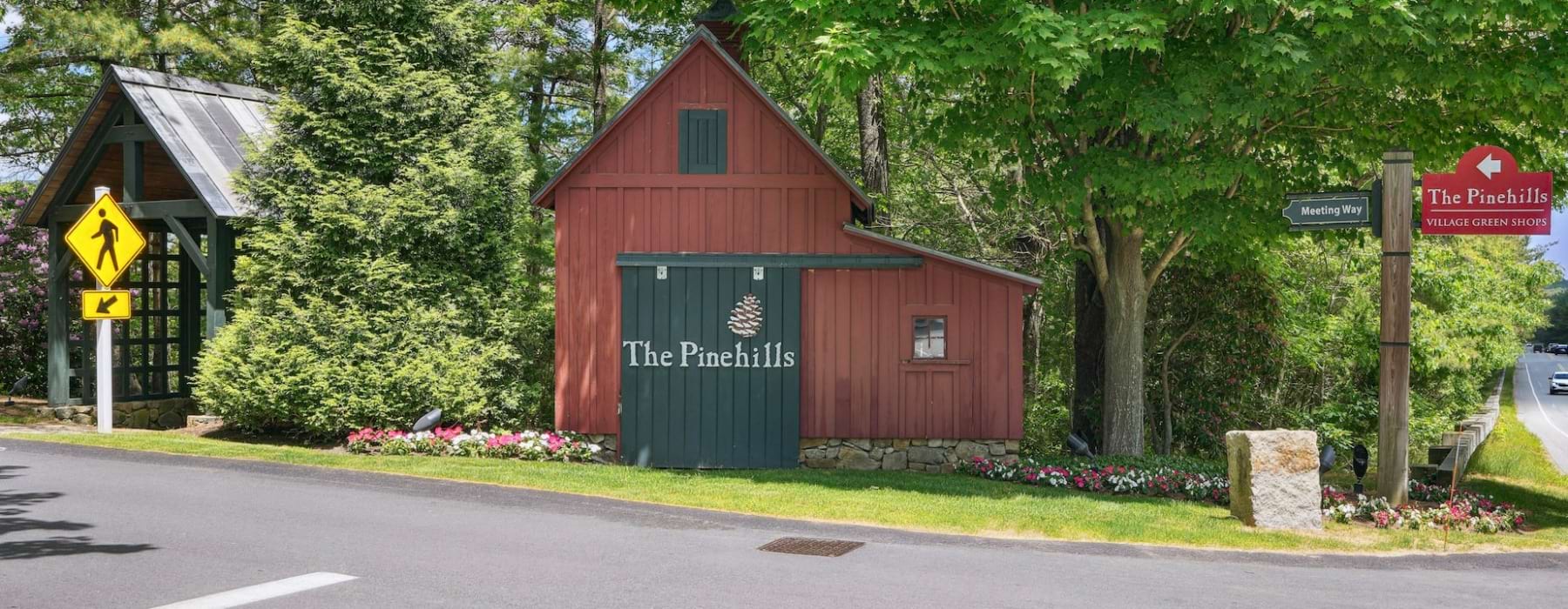The Pinehills red barn at Meeting Way street entry