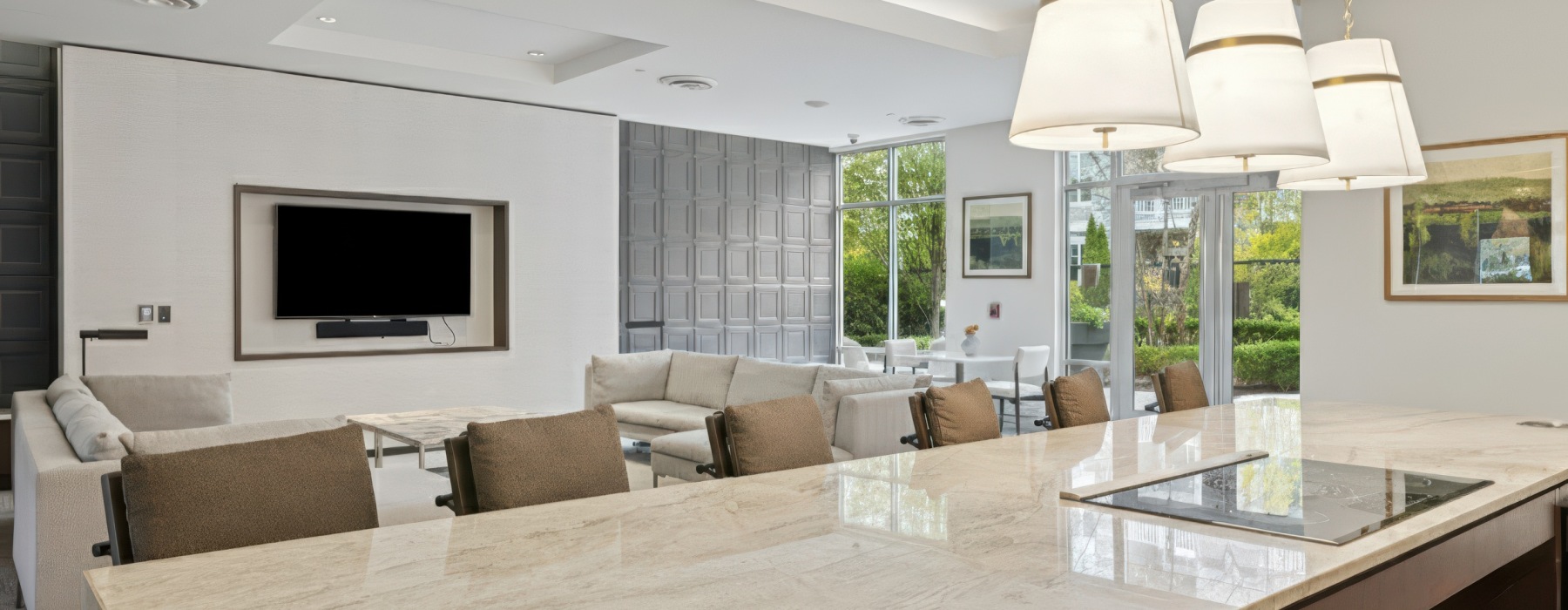 Lounge with bar seating, couches, TV and stove in entertainment kitchen